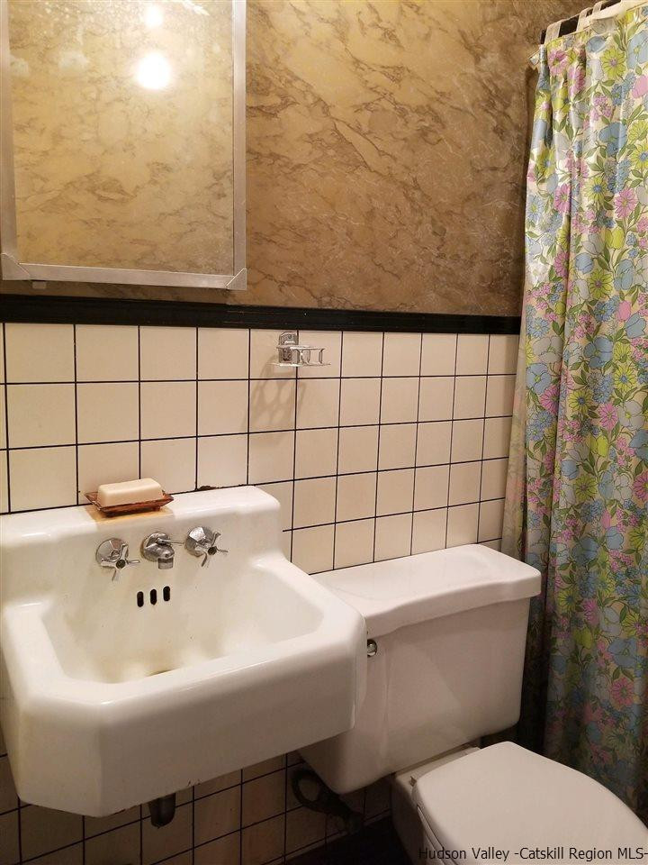 545 Upper Cherrytown Road Kerhonkson, NY 12446 - Photo 31 of 35 a white sink sitting next to a white toilet