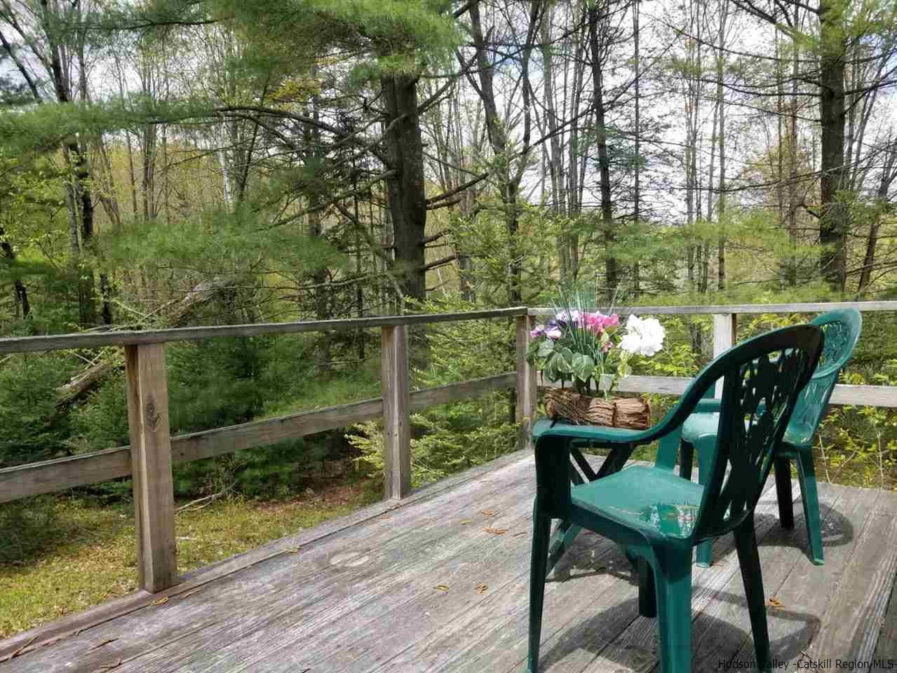 545 Upper Cherrytown Road Kerhonkson, NY 12446 - Photo 32 of 35 a view of a chairs and table on the wooden deck
