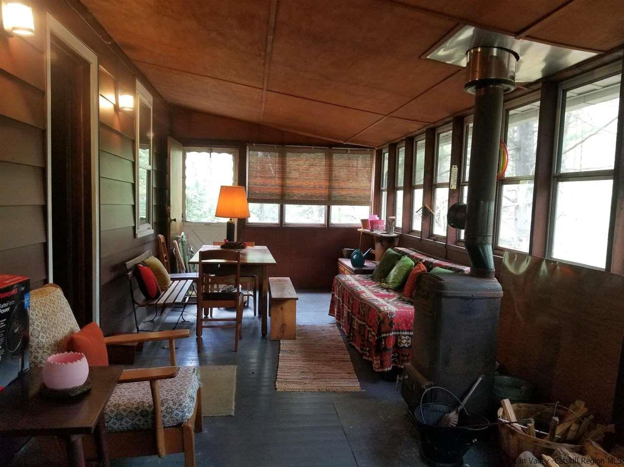 545 Upper Cherrytown Road Kerhonkson, NY 12446 - Photo 7 of 35 a living room with furniture and a large window