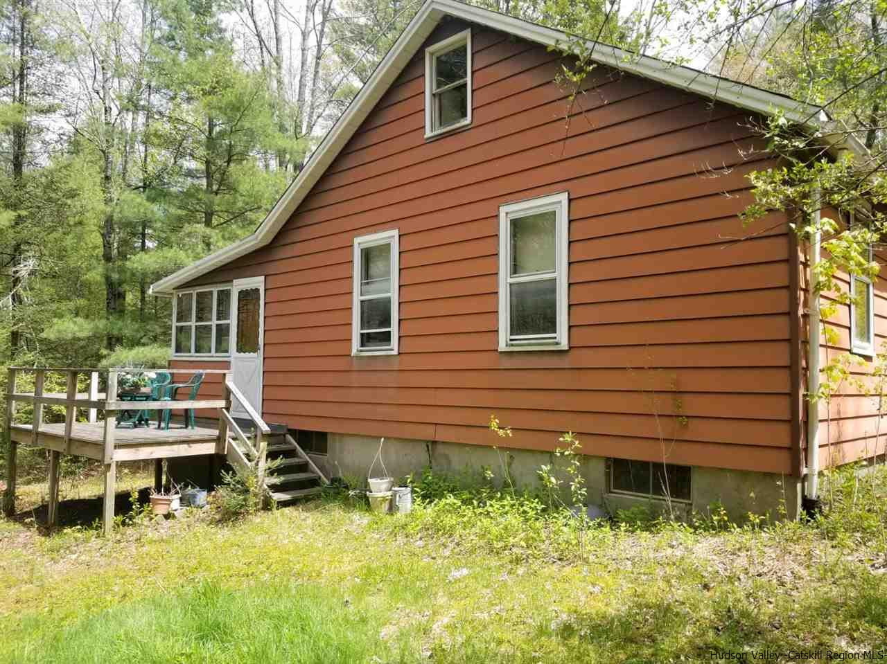 545 Upper Cherrytown Road Kerhonkson, NY 12446 - Photo 10 of 35 a backyard of a house with large trees and plants