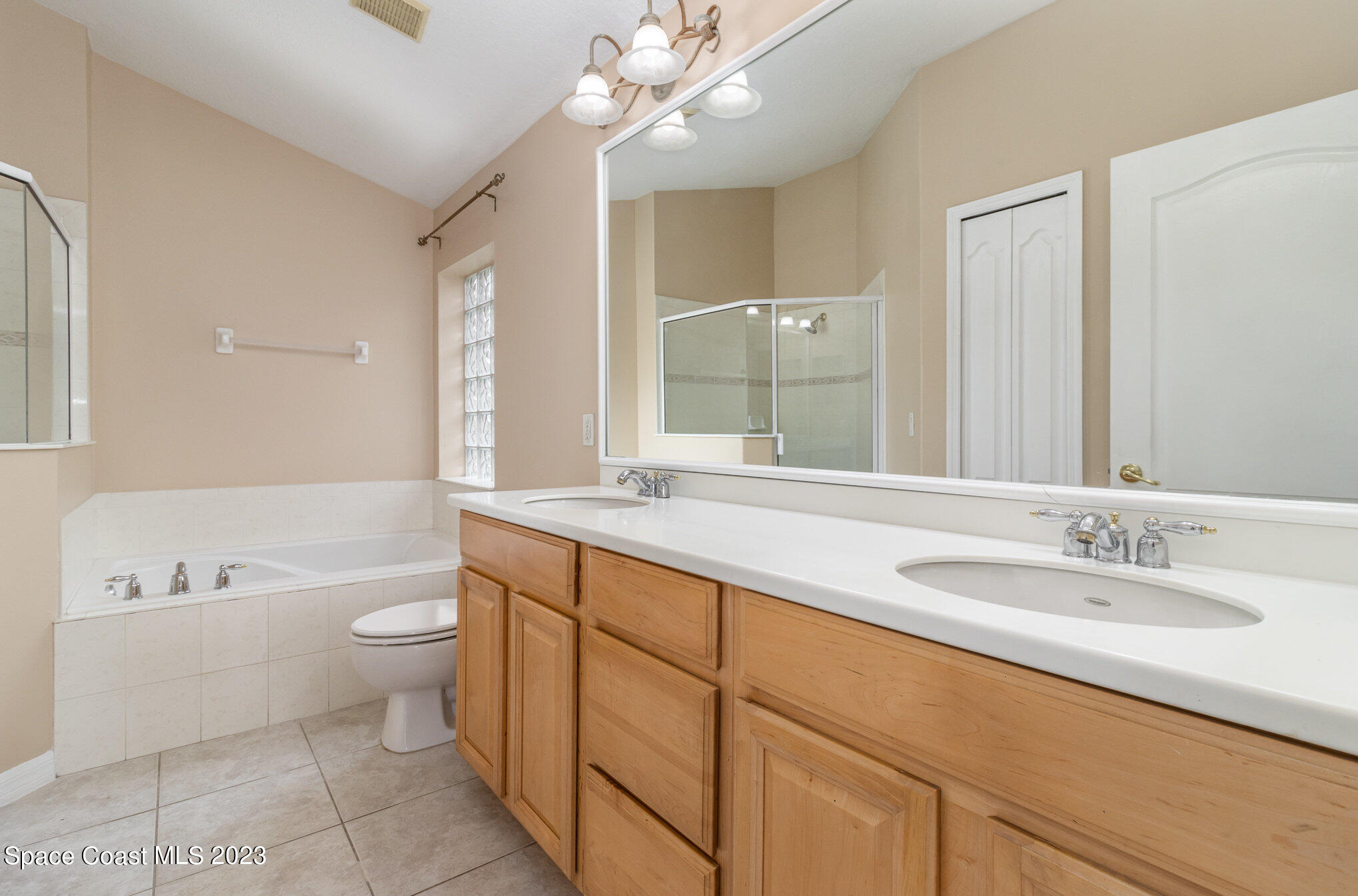 3504 Fodder Drive Rockledge, FL 32955 - Photo 12 of 20 a bathroom with a granite countertop sink a toilet a large mirror and shower