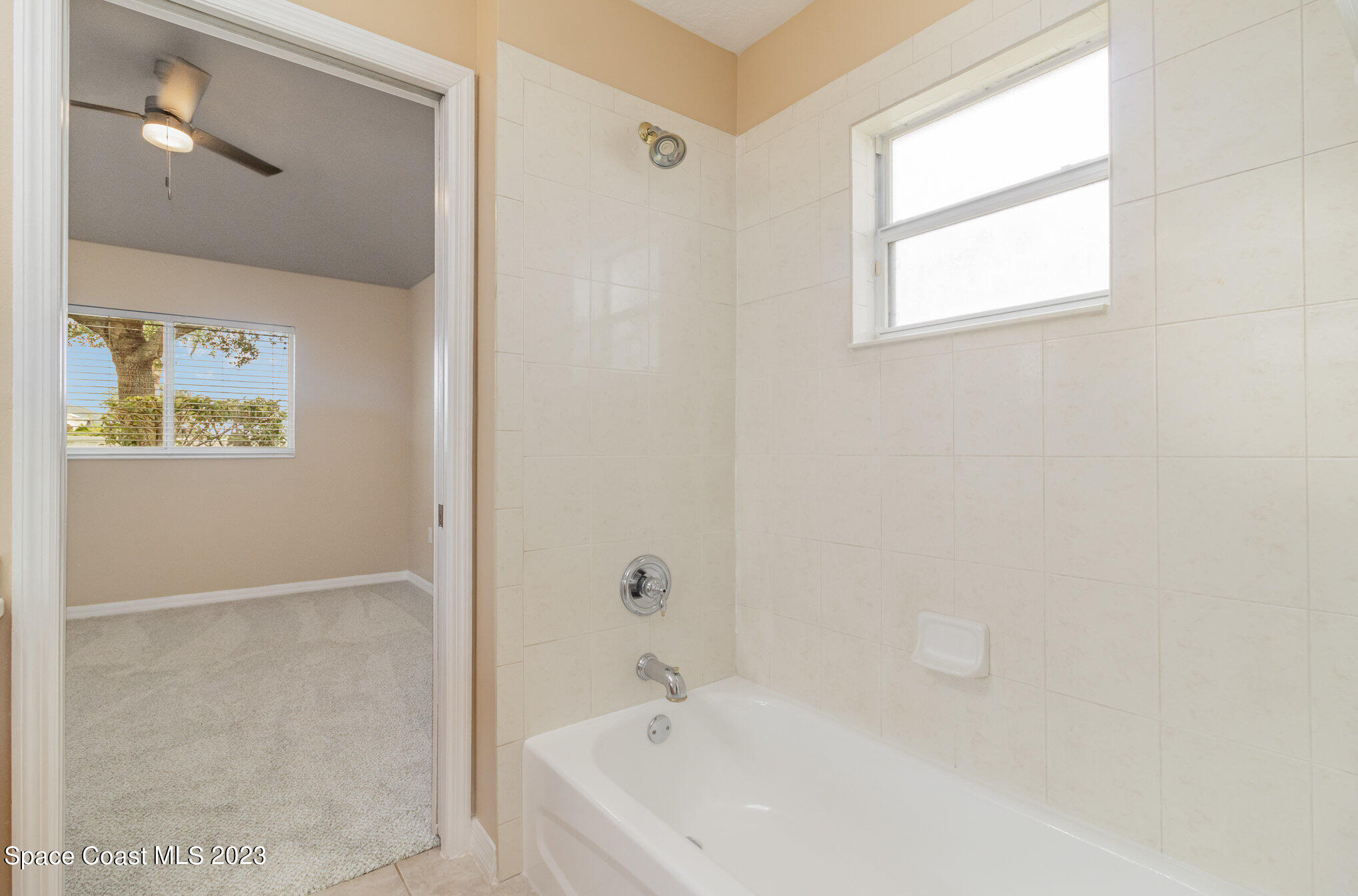 3504 Fodder Drive Rockledge, FL 32955 - Photo 16 of 20 a white bath tub sitting next to a white sink and vanity