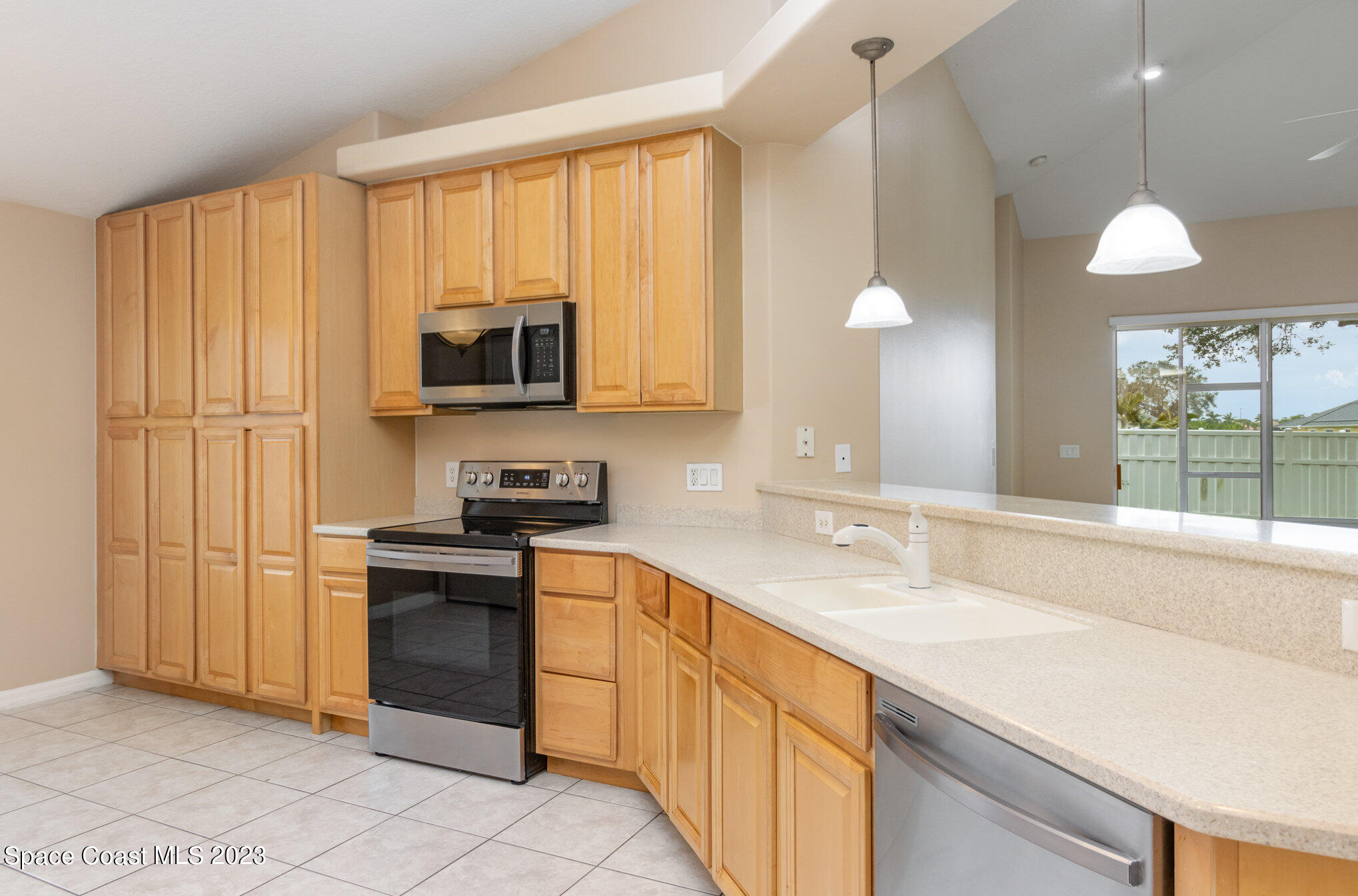 3504 Fodder Drive Rockledge, FL 32955 - Photo 3 of 20 a kitchen with stainless steel appliances granite countertop a sink and a stove