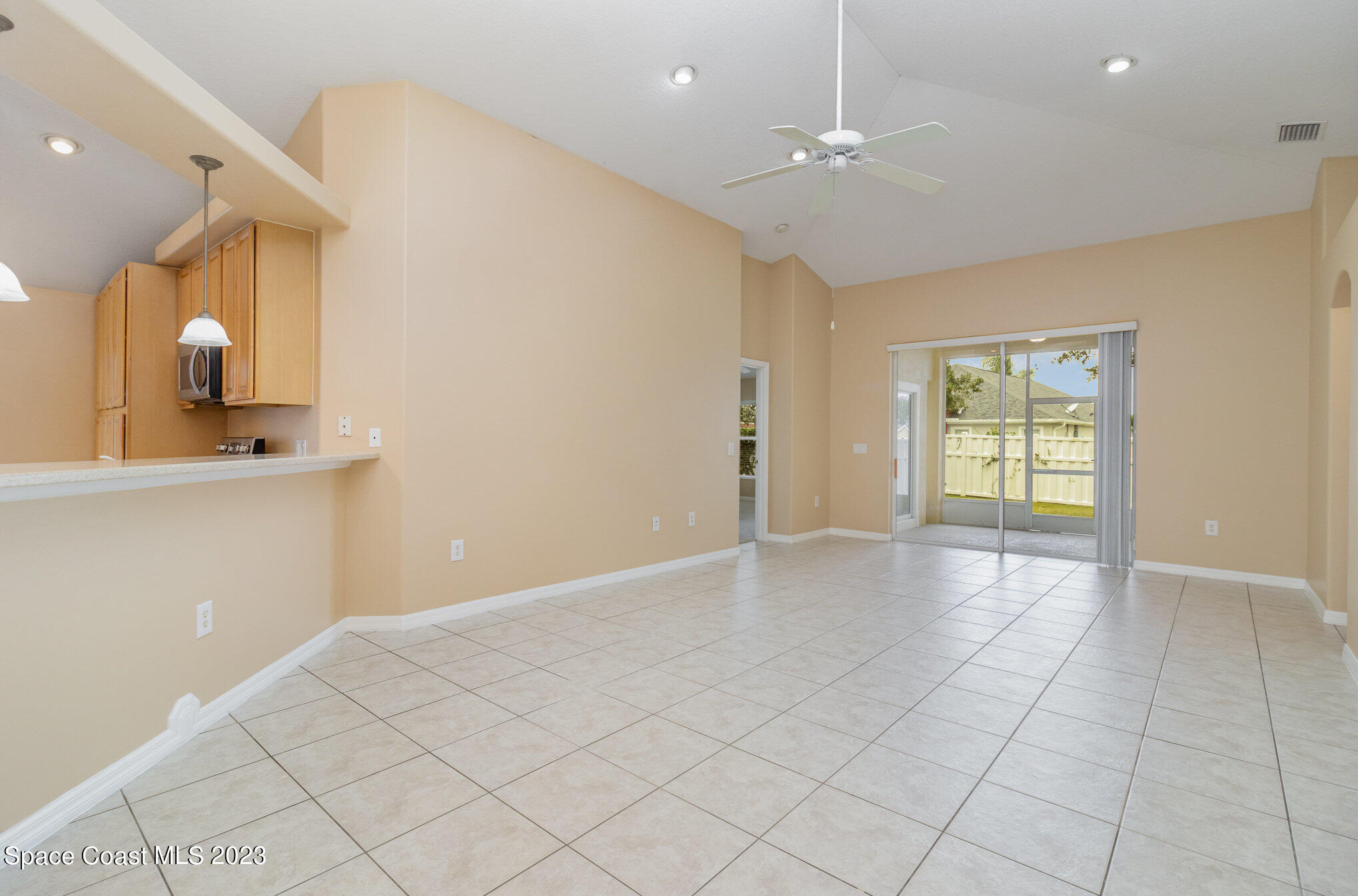 3504 Fodder Drive Rockledge, FL 32955 - Photo 6 of 20 a view of an empty room with window and wooden floor