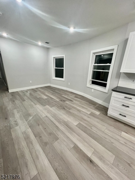 626 South 20th Street, Unit 3 Newark, NJ 07103 - Photo 4 of 11 a view of an empty room with wooden floor and windows