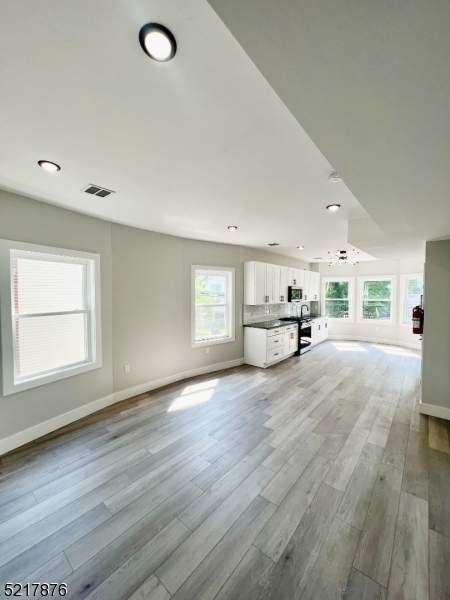 626 South 20th Street, Unit 3 Newark, NJ 07103 - Photo 5 of 11 a view of a livingroom with furniture window and wooden floor
