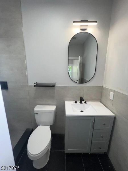 626 South 20th Street, Unit 3 Newark, NJ 07103 - Photo 7 of 11 a bathroom with a toilet sink and mirror