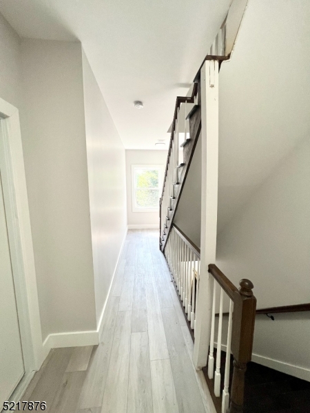 626 South 20th Street, Unit 3 Newark, NJ 07103 - Photo 10 of 11 a view of a hallway with wooden floor and staircase