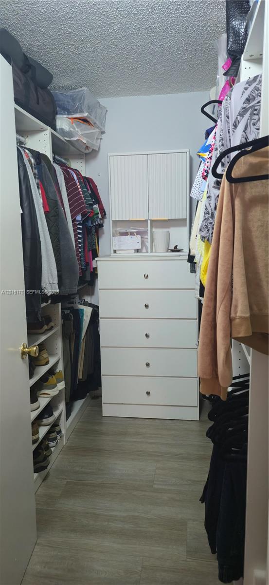 8002 Southwest 149th Avenue, Unit B216 Miami, FL 33193 - Photo 15 of 21 a view of walk in closet with clothes and shoes