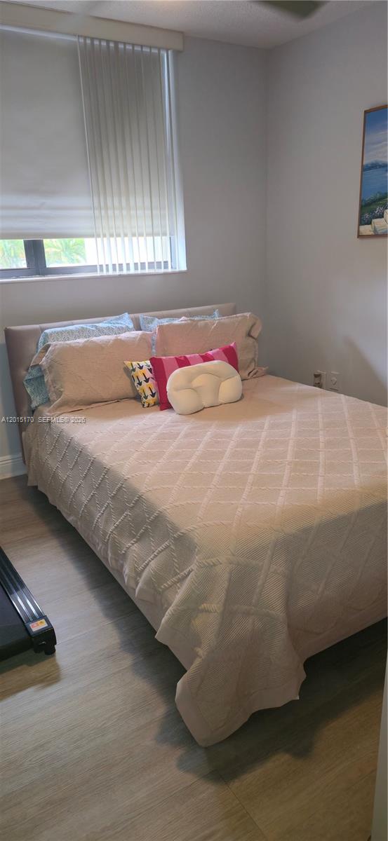 8002 Southwest 149th Avenue, Unit B216 Miami, FL 33193 - Photo 9 of 21 a bedroom with a bed and window