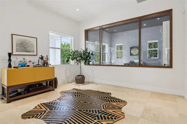 a living room with a couch and a potted plant