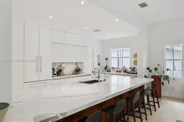 a kitchen with counter top space and wooden floor
