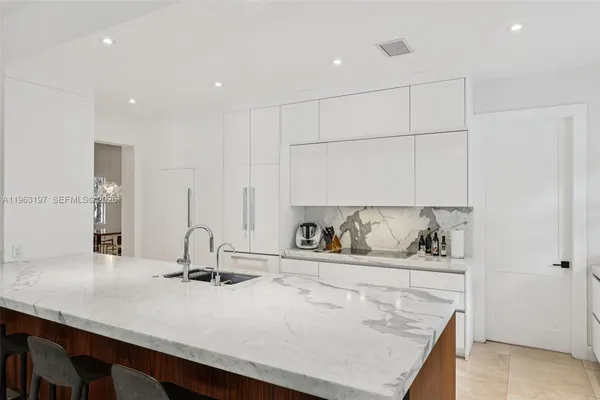 a kitchen with kitchen island a sink and stove