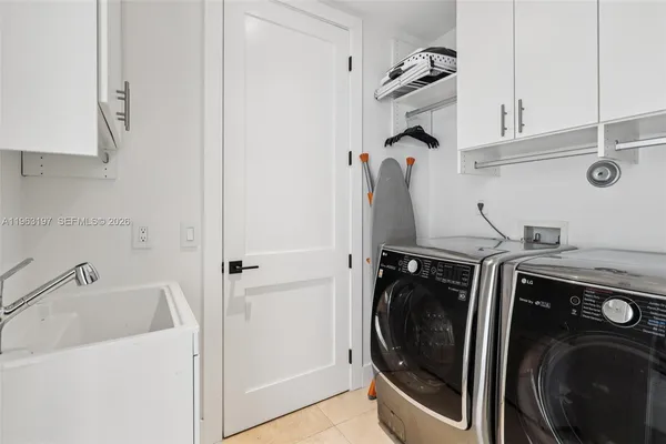 a utility room with sink dryer and washer