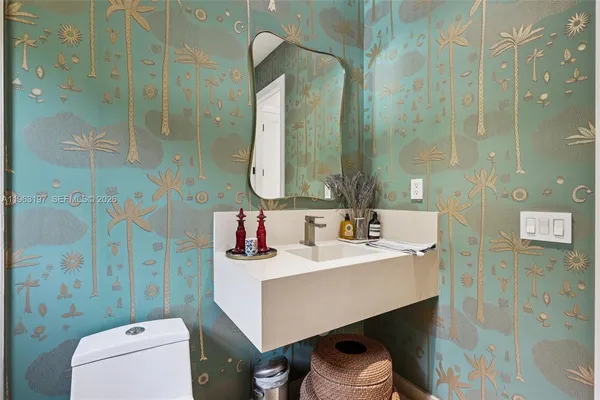 a bathroom with a toilet sink and mirror