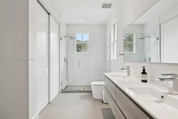 a bedroom with bed and window