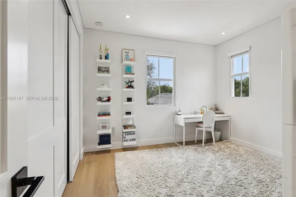 a spacious bedroom with a bed and a couch