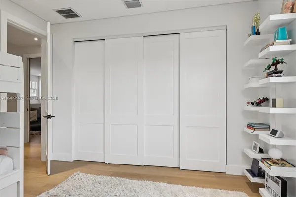 a bathroom with a double vanity sink mirror and bathtub