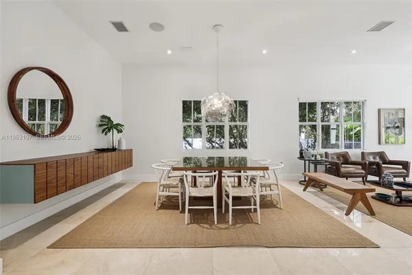 a dining room with wooden floor and a chandelier