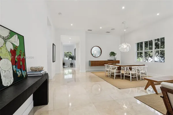 a view of a dining room with furniture and a mirror