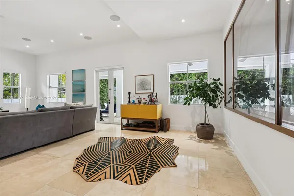 a living room with furniture and a potted plant
