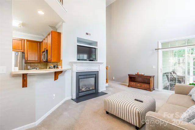 a bedroom with furniture a flat screen tv and a fireplace