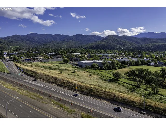 a view of a house with a yard and a mountain