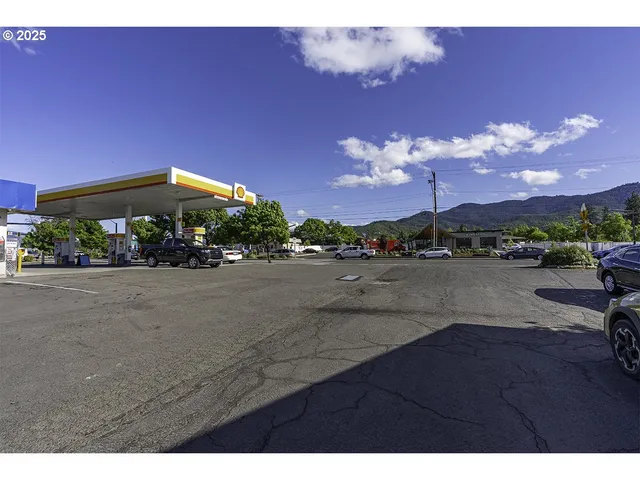 a view of a street with a table and chairs