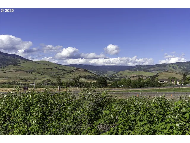 a view of a lake with sunset in the background
