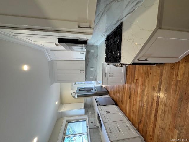 a kitchen with granite countertop a sink a stove and refrigerator