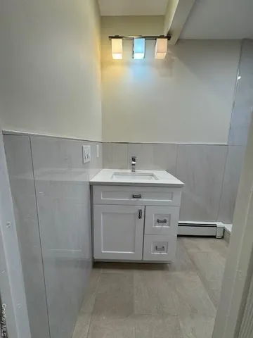 a view of a kitchen with white cabinets