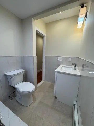a bathroom with a sink toilet and a mirror