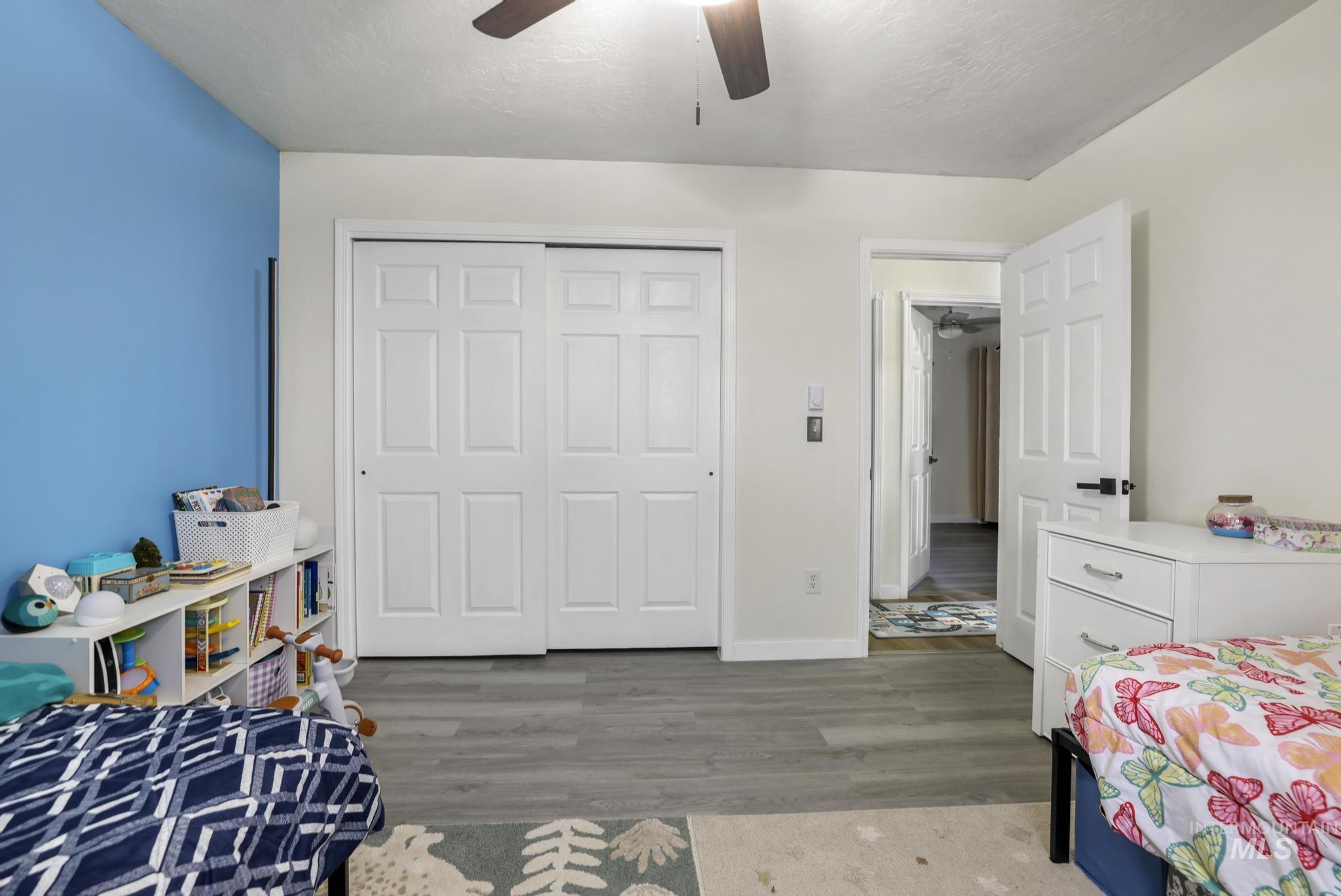 3083 Dickson Avenue Twin Falls, ID 83301 - Photo 13 of 26 Bedroom with light wood-style floors, a closet, and a ceiling fan