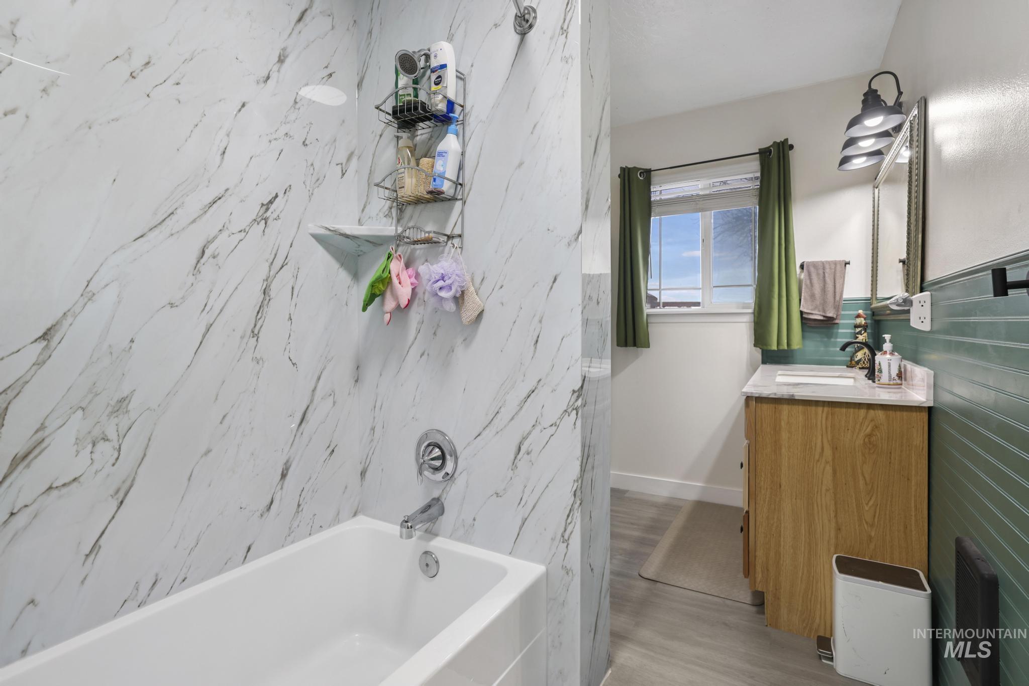 3083 Dickson Avenue Twin Falls, ID 83301 - Photo 16 of 26 Full bathroom with shower / washtub combination, vanity, and light wood-style flooring