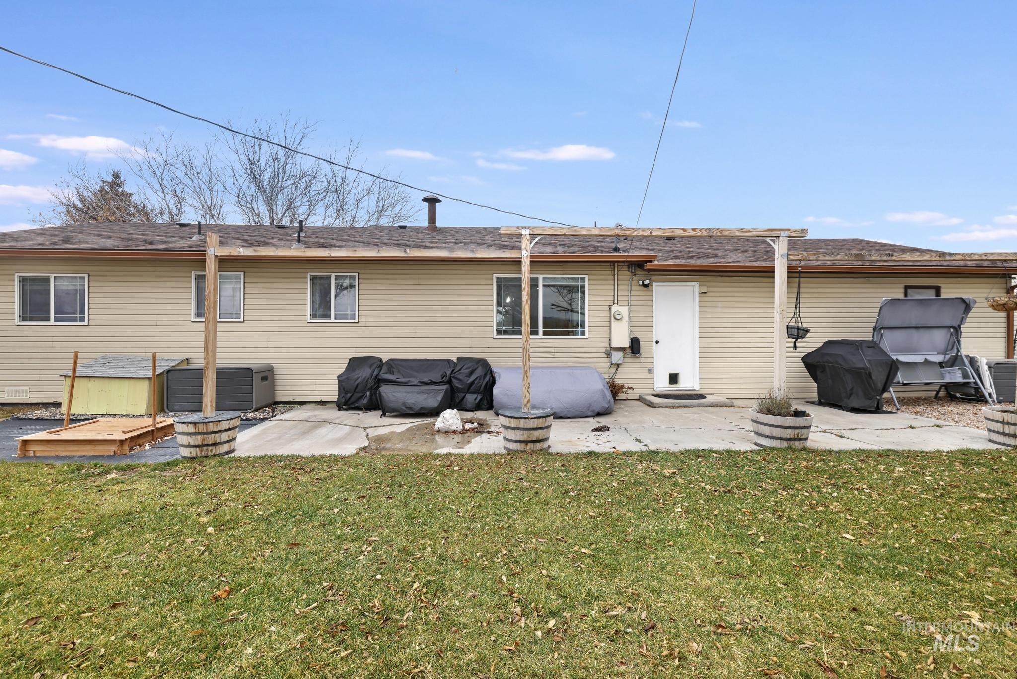 3083 Dickson Avenue Twin Falls, ID 83301 - Photo 22 of 26 Rear view of property with a patio area, a lawn, and roof with shingles