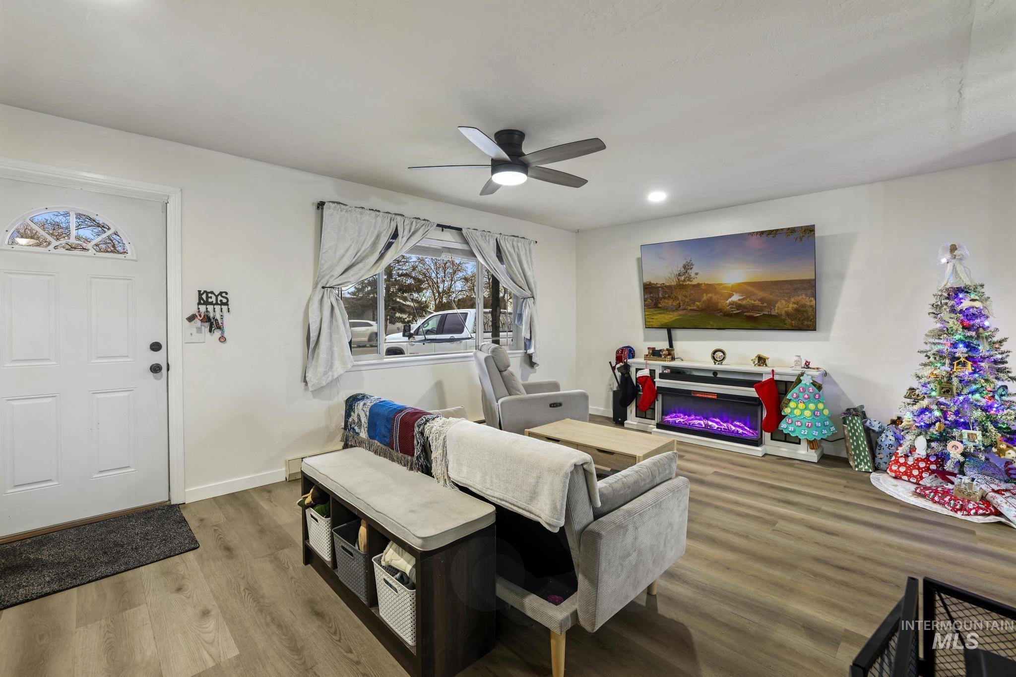 3083 Dickson Avenue Twin Falls, ID 83301 - Photo 3 of 26 Living room with wood finished floors, a glass covered fireplace, recessed lighting, and ceiling fan