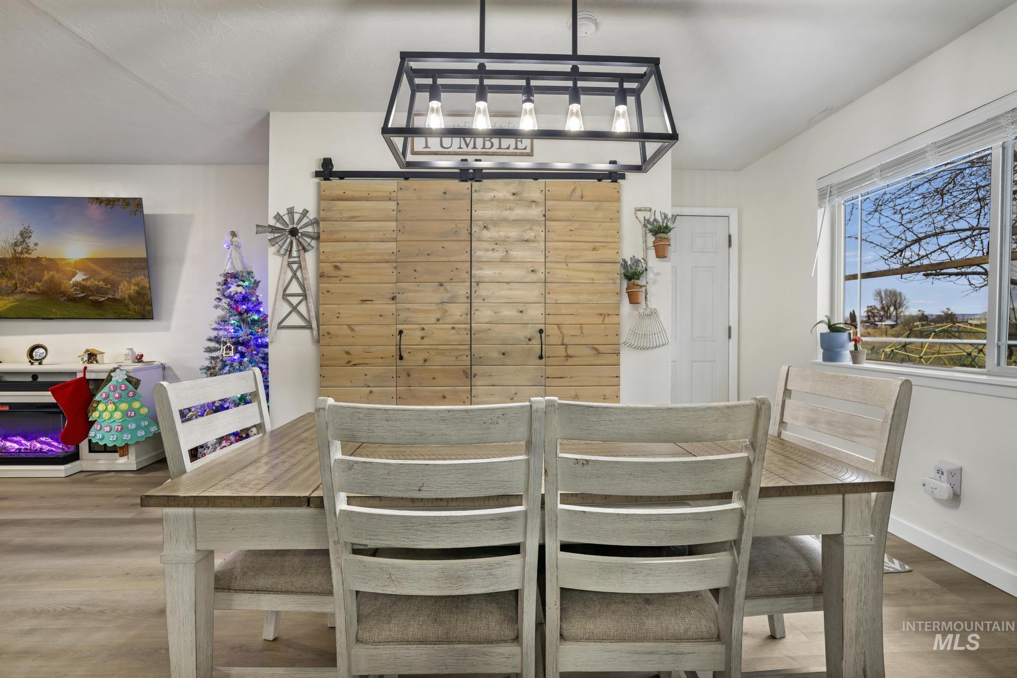 3083 Dickson Avenue Twin Falls, ID 83301 - Photo 10 of 26 Dining space with light wood finished floors and a barn door