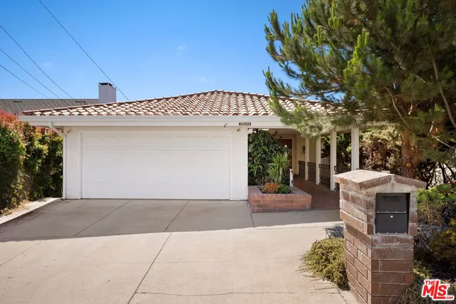 a front view of a building with tree
