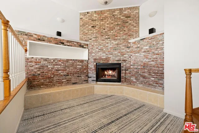 a bathroom with a bathtub and a wooden floor