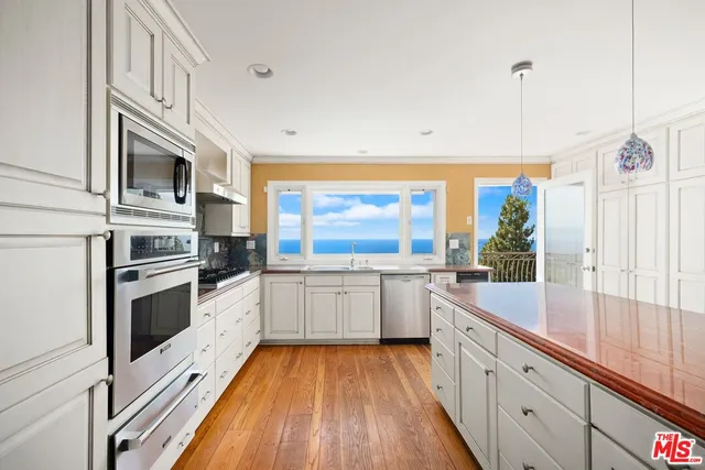 a kitchen with stainless steel appliances granite countertop a stove and a sink