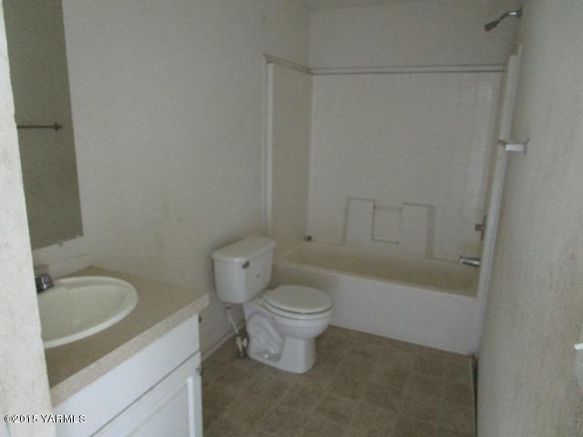 10200 Ahtanum Road Yakima, WA 98903 - Photo 9 of 38 a white toilet sitting next to a bath tub