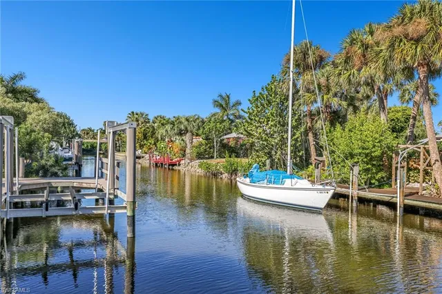 a view of a lake with lawn chairs