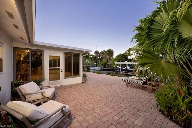 a view of a house with backyard and sitting area