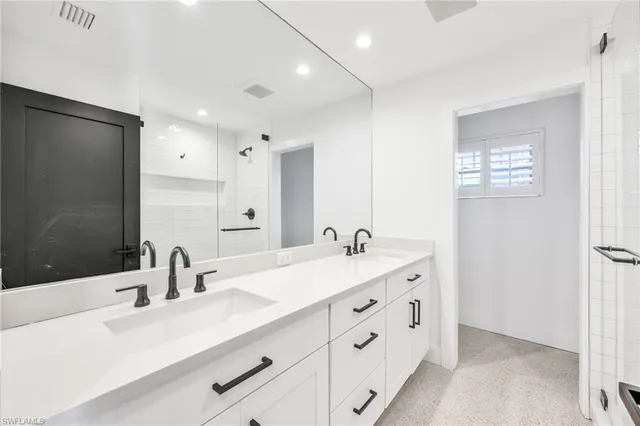 a bathroom with a double vanity sink and mirror