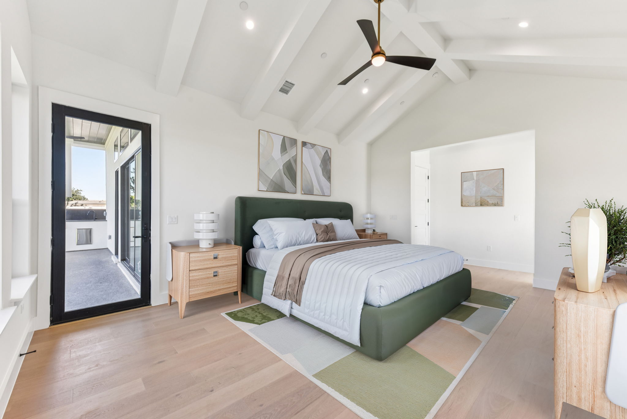 6010 Adhara Pass Austin, TX 78730 - Photo 14 of 38 a bedroom with a large bed and a chandelier
