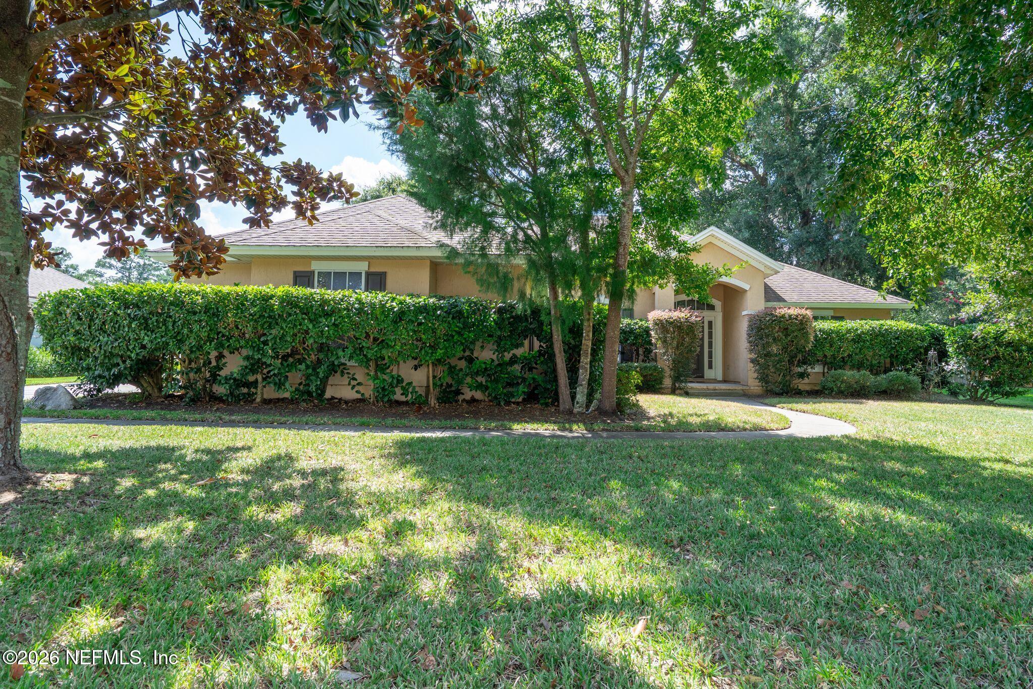 a front view of house with yard and green space