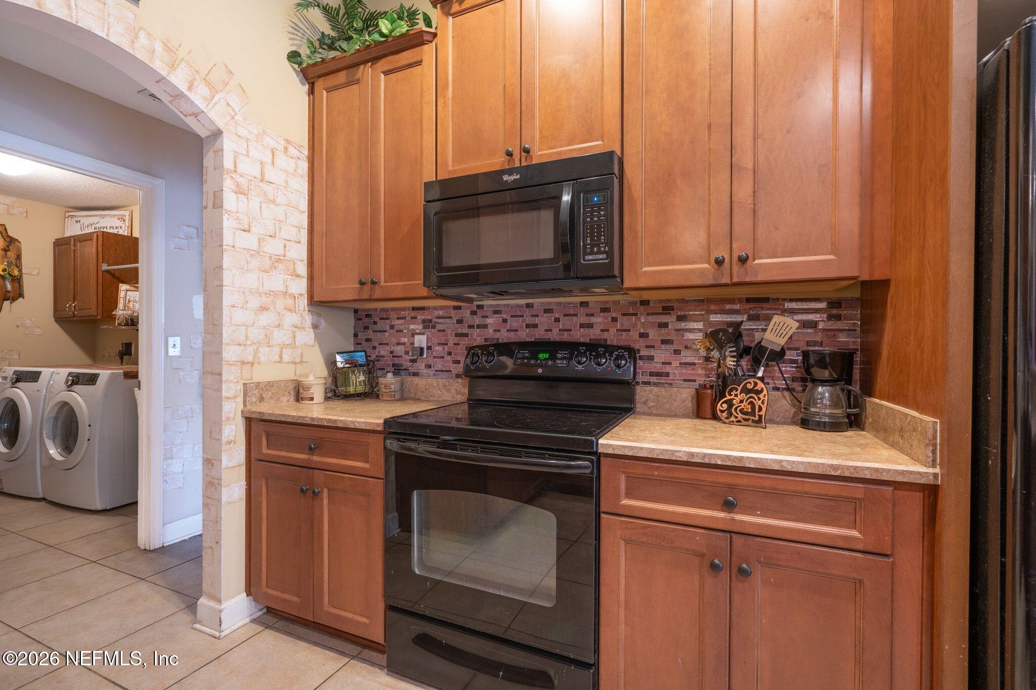 97447 Bluff View Circle Yulee, FL 32097 - Photo 11 of 19 a kitchen with a stove and a sink