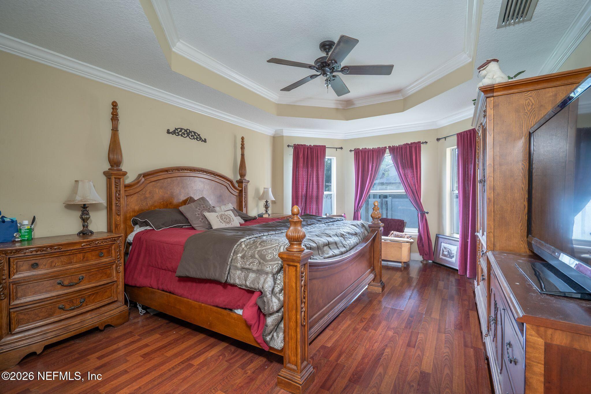 97447 Bluff View Circle Yulee, FL 32097 - Photo 13 of 19 a bedroom with a bed and a flat screen tv