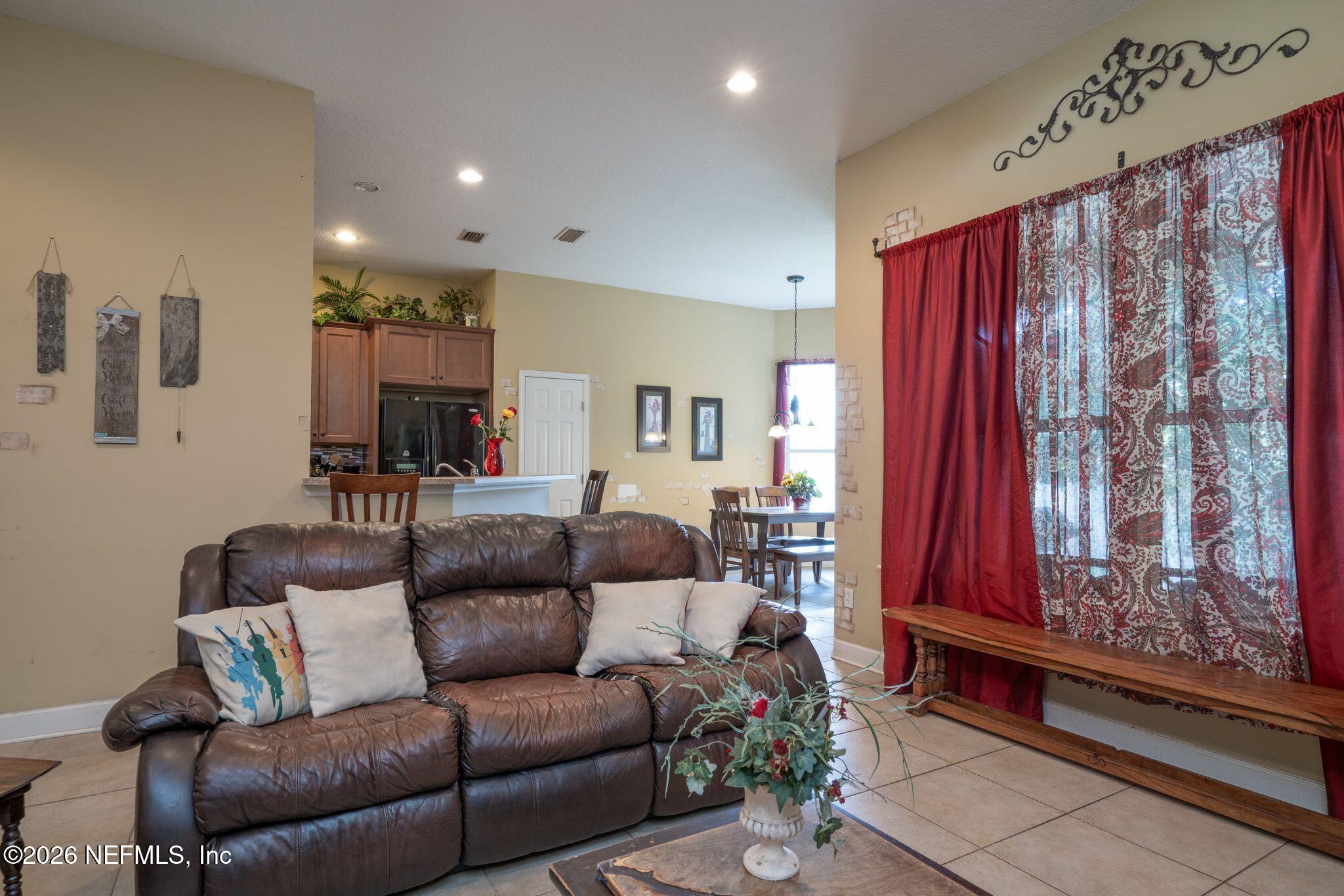 97447 Bluff View Circle Yulee, FL 32097 - Photo 6 of 19 a living room with furniture and a large window