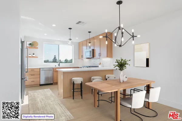a kitchen with stainless steel appliances granite countertop a sink a stove and a refrigerator